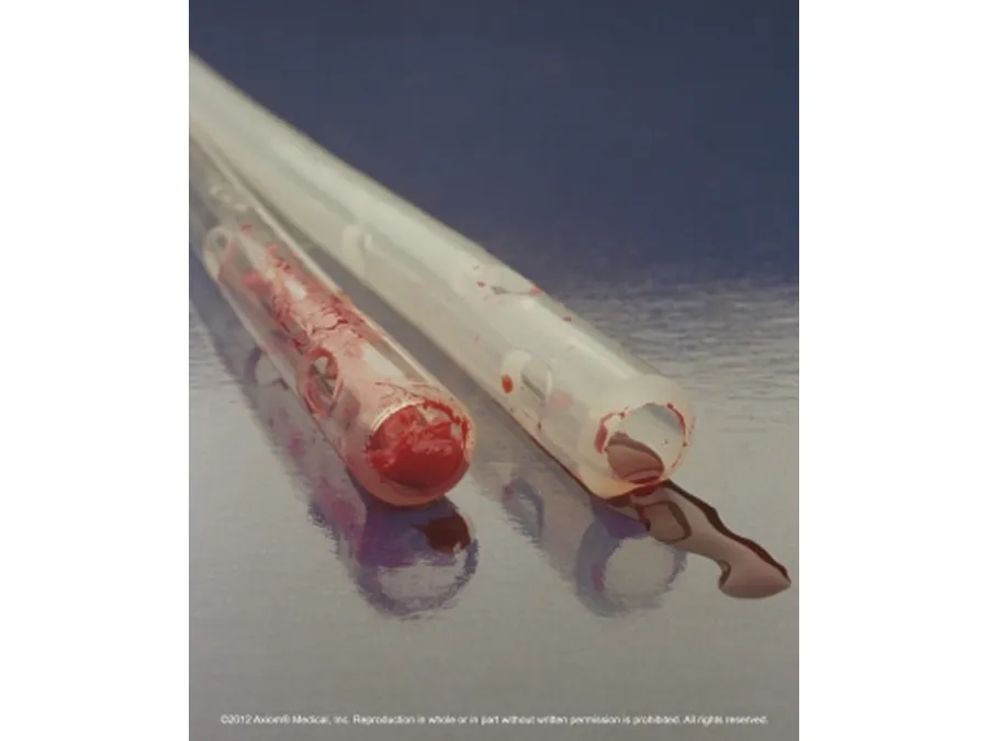 Two medical suction catheters, one with visible blood inside and outside, lying on a reflective surface.